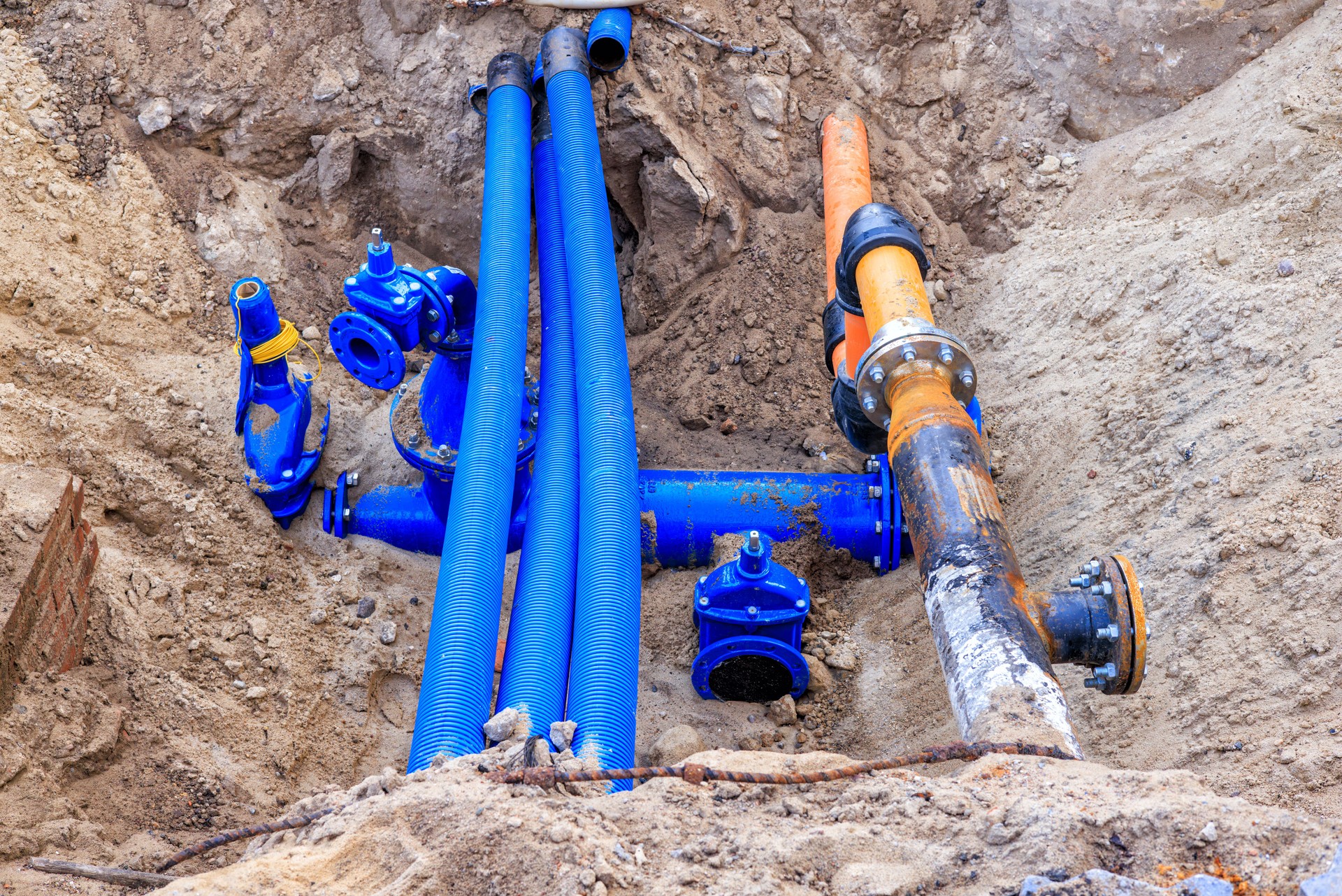 Laying new water and cable pipes for city communications. Repair pit.